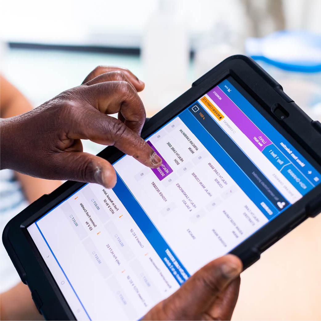 Nurse using a Mitie iPad to select a patient's menu choices